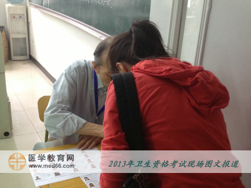 2013年衛(wèi)生專業(yè)技術(shù)考試考場-考官認(rèn)真核查考生信息